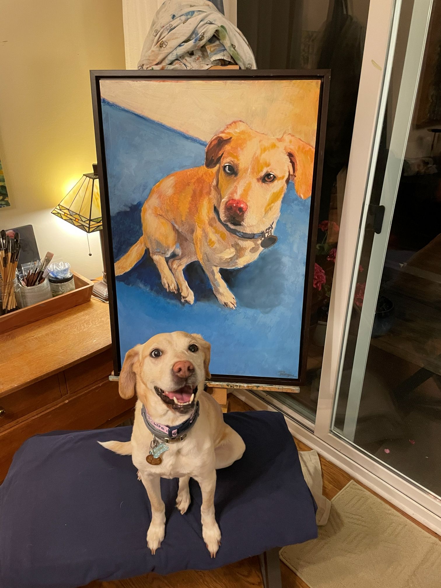 Sunny the dog beside her finished painted portrait